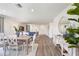 Elegant dining room with a wood table, white chairs, and hardwood floors at 2235 Majestic Span Ave, Eagle Lake, FL 33839