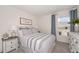 Cozy bedroom with a queen-size bed, neutral decor, and large window at 2235 Majestic Span Ave, Eagle Lake, FL 33839