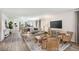 Open concept living room showcasing hardwood floors and ample natural light at 2235 Majestic Span Ave, Eagle Lake, FL 33839
