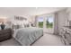 Spacious bedroom with a king-size bed, ample natural light, and grey carpet at 2235 Majestic Span Ave, Eagle Lake, FL 33839