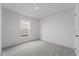 Spacious bedroom featuring grey carpet and a large window at 2211 Majestic Span Ave, Eagle Lake, FL 33839