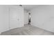 Bright bedroom with grey carpet and a door to another room at 2211 Majestic Span Ave, Eagle Lake, FL 33839