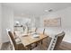Bright dining room with a large wooden table and neutral decor at 2211 Majestic Span Ave, Eagle Lake, FL 33839