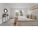Bright bedroom with large windows and decorative mirror at 2211 Majestic Span Ave, Eagle Lake, FL 33839