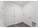 Laundry room with white walls, grey floor, and a door at 2211 Majestic Span Ave, Eagle Lake, FL 33839