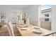 Bright dining room with light wood table and six chairs at 2211 Majestic Span Ave, Eagle Lake, FL 33839