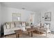 Living room with a comfy sofa, two armchairs, and a coffee table at 2211 Majestic Span Ave, Eagle Lake, FL 33839