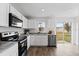 Modern kitchen features stainless steel appliances and backyard access at 2211 Majestic Span Ave, Eagle Lake, FL 33839