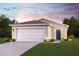 Charming single-story home with a two-car garage and landscaped front yard at 2366 Aquiline Nest St, Eagle Lake, FL 33839