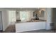 Open kitchen with gray cabinets and breakfast bar at 1412 Swan Ct, Poinciana, FL 34759