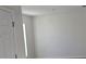 Simple bedroom with white walls and a door at 1412 Swan Ct, Poinciana, FL 34759