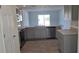 Modern kitchen with gray cabinets and stainless steel appliances at 1412 Swan Ct, Poinciana, FL 34759