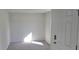 Simple bedroom with carpeted floors and an exterior door at 1412 Swan Ct, Poinciana, FL 34759