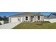 Nice two-bedroom house with a white garage door and green lawn at 1412 Swan Ct, Poinciana, FL 34759
