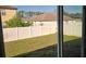 Fenced backyard with grass and some trees at 1412 Swan Ct, Poinciana, FL 34759