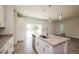Kitchen island with granite countertops, stainless steel sink, and pendant lighting at 802 Fraser Dr, Poinciana, FL 34759