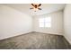 Bright bedroom featuring grey carpet and a window at 802 Fraser Dr, Poinciana, FL 34759