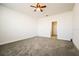 Spacious bedroom with grey carpet and access to bathroom at 802 Fraser Dr, Poinciana, FL 34759