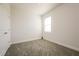 Simple bedroom with grey carpet and a window with blinds at 802 Fraser Dr, Poinciana, FL 34759