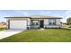 Modern one-story home with gray and white exterior and two-car garage at 802 Fraser Dr, Poinciana, FL 34759