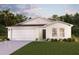 Charming single-story house with a two-car garage and landscaped lawn at 13012 Se 53Rd Ave, Belleview, FL 34420