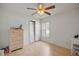 Simple bedroom with dresser, closet, and ceiling fan at 15718 Heron Hill St, Clermont, FL 34714