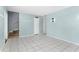 Living room with tiled floor and teal walls at 5675 Charleston St # 58, Orlando, FL 32807