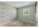 Bedroom with floral wallpaper and carpet at 5675 Charleston St # 58, Orlando, FL 32807