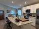 Modern kitchen features white cabinets, granite countertops, and a large island at 724 Caribbean Dr, Mulberry, FL 33860