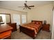 Bedroom with a wooden bed frame and two windows at 2033 Estancia Cir # B, Kissimmee, FL 34741