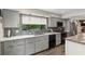 Modern kitchen with gray cabinets, stainless steel appliances, and marble countertops at 29 Lake Wood Cir, Ocala, FL 34482