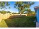 Large backyard with wooden fence and green lawn at 2203 Nottingham Rd, South Daytona, FL 32119