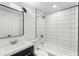 Modern bathroom with white subway tile, bathtub, and updated vanity at 2203 Nottingham Rd, South Daytona, FL 32119