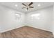 Bright bedroom with wood-look floors and ceiling fan at 2203 Nottingham Rd, South Daytona, FL 32119