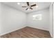 Bright bedroom with wood-look floors and ceiling fan at 2203 Nottingham Rd, South Daytona, FL 32119
