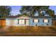 Newly renovated light blue house with a white trim and a spacious lawn at 2203 Nottingham Rd, South Daytona, FL 32119