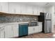 Modern kitchen with blue island, white cabinets, and new appliances at 2203 Nottingham Rd, South Daytona, FL 32119