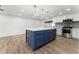 Modern kitchen with blue island, white cabinets, and new appliances at 2203 Nottingham Rd, South Daytona, FL 32119