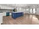 Modern kitchen with blue island, white cabinets, and new appliances at 2203 Nottingham Rd, South Daytona, FL 32119