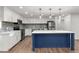 Modern kitchen with blue island, white cabinets, and new appliances at 2203 Nottingham Rd, South Daytona, FL 32119