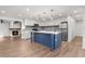 Modern kitchen with blue island, white cabinets, and new appliances at 2203 Nottingham Rd, South Daytona, FL 32119