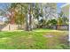 Large backyard with mature trees and a wooden fence at 4251 Tangerine Ave, Sanford, FL 32773