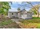 Backyard with patio, mature trees, and a wooden fence at 4251 Tangerine Ave, Sanford, FL 32773