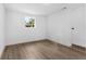 Bright bedroom with wood-look flooring and neutral walls at 4251 Tangerine Ave, Sanford, FL 32773