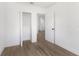 Spacious bedroom with wood-look flooring and access to closet at 4251 Tangerine Ave, Sanford, FL 32773