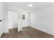 Well-lit bedroom featuring wood-look flooring and neutral walls at 4251 Tangerine Ave, Sanford, FL 32773