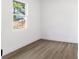 Simple bedroom with wood-look flooring and a large window at 4251 Tangerine Ave, Sanford, FL 32773