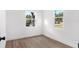 Charming bedroom with wood-look flooring and two windows at 4251 Tangerine Ave, Sanford, FL 32773