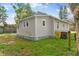 Side view of the updated bungalow with mature landscaping at 4251 Tangerine Ave, Sanford, FL 32773