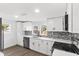 Modern kitchen with white shaker cabinets and gray backsplash at 4251 Tangerine Ave, Sanford, FL 32773